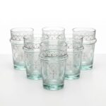 A matching set of six clear white geometric tea glasses with traditional Moroccan ridges and delicate white painted designs, arranged perfectly against a clean white studio background.