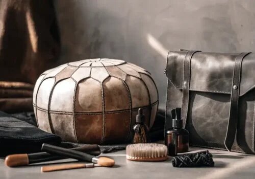 Traditional Moroccan leather goods with natural care products and tools arranged artistically