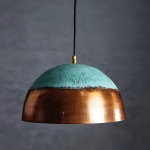 Artistic shot of verdigris dome lamp against dark background