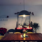 Black dome pendant light over dining table in modern home setting