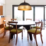 Brass dome pendant light over dining table setting