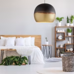 Brass globe pendant light in modern bedroom setting
