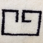Close-up of geometric corner detail on minimalist Moroccan rug