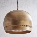 Close-up of handcrafted brass dome pendant light showing detailed engravings