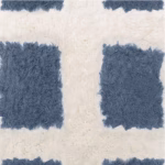 Close-up of gray geometric grid pattern on handwoven Moroccan rug