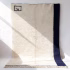 Full view of Moroccan minimalist rug showing navy border design