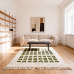Grid pattern Moroccan rug with green squares displayed in contemporary living space with cream sofa and wooden shelving unit