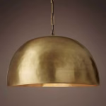 Handcrafted brass dome pendant light against dark background showing metallic finish