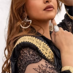 Model wearing geometric triangle hoop earrings