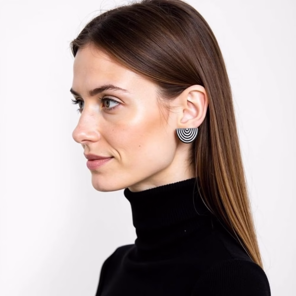 Model wearing silver striped half circle studs