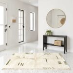 Moroccan Berber rug flat lay handwoven wool geometric olive patterns cream background with tassel fringe