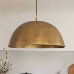 Modern brass dome pendant light in minimalist kitchen setting