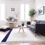 Modern white and navy Moroccan rug styled in contemporary living room