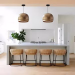 Pair of engraved brass dome pendant lights over modern kitchen island