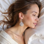 Side view of silver filigree earrings on model