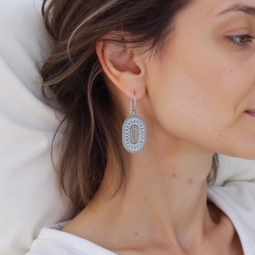 Side view of silver oval earrings