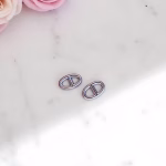Silver circle stud earrings on marble