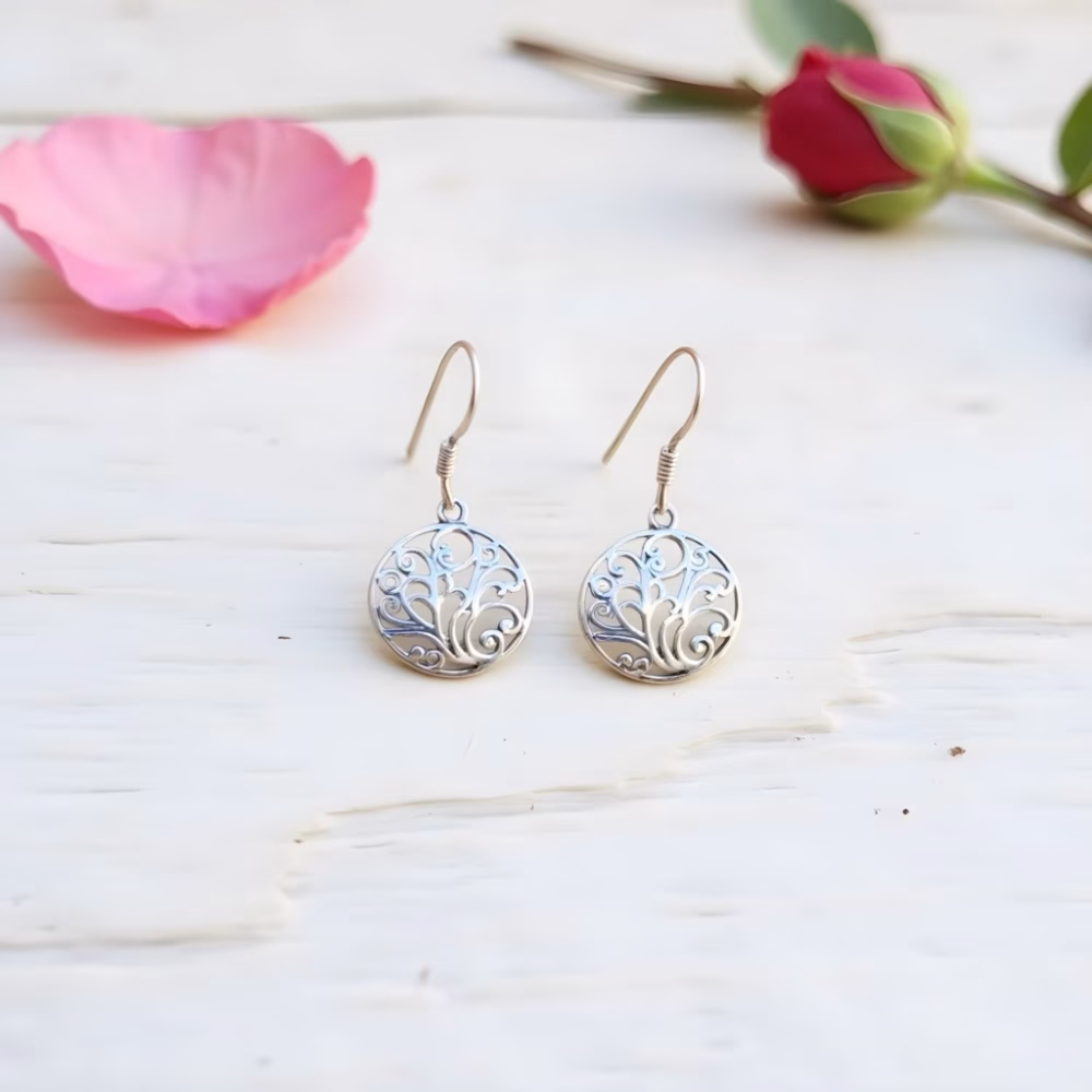 Sterling silver filigree earrings on white surface
