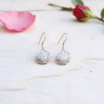 Sterling silver filigree earrings on white surface