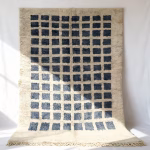 gray grid pattern Moroccan rug with traditional fringe detail