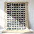 Modern wool rug with ombré blue gradient grid pattern on cream base with fringe detail