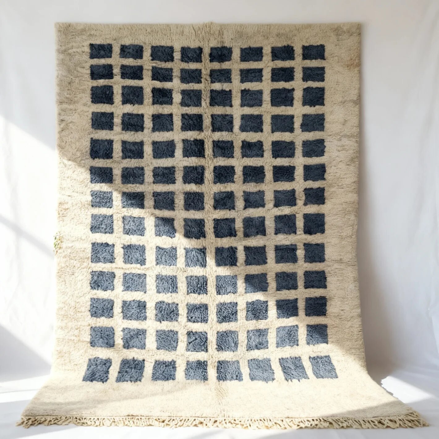 gray grid pattern Moroccan rug with traditional fringe detail Modern wool rug with ombré blue gradient grid pattern on cream base with fringe detail