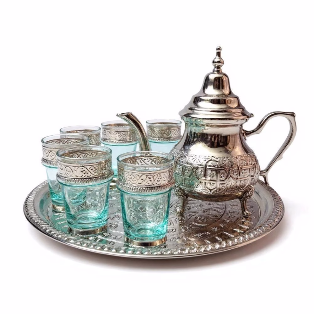 Elegant silver-plated Moroccan engraved tea set with mint tea glasses on decorative tray