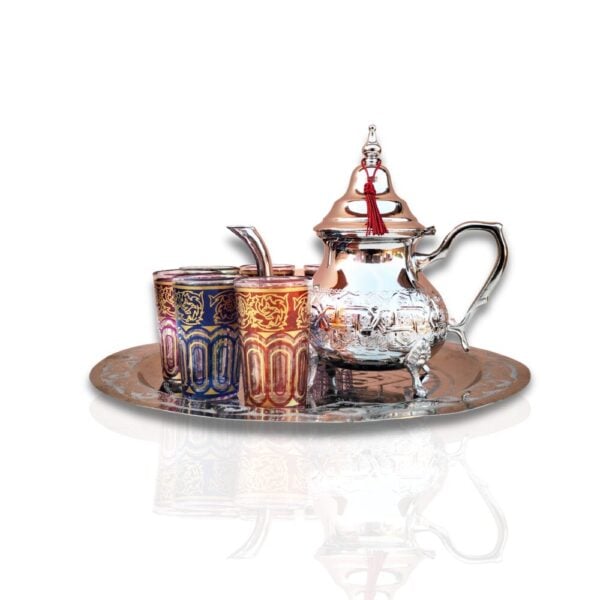Authentic Moroccan mint tea set with silver teapot and multicolored glasses on ornate tray