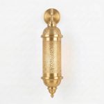 Brass wall sconce front view showing detailed pierced geometric and floral metalwork, round mounting backplate, artisan-made in Marrakech
