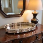 Hammered silver tray with Moorish filigree border displayed on rustic wooden table