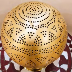 Globe-shaped table lamp detail of geometric pattern work