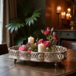 Hammered silver tray with pierced gallery rim styled with pillar candles and pink floral arrangement