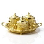 Hand-engraved brass sugar bowl set with three lidded containers and ornate serving tray featuring decorative patterns