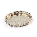 Hand-hammered silver serving tray with ornate filigree border, oval shape with textured surface detail