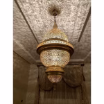 Illuminated brass lampshade showcasing traditional engravings