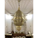 Moroccan engraved brass pendant light 80cm with perforated dome, unlit in modern living room setting