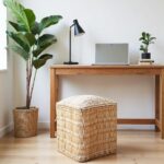 Minimalist home office with natural straw ottoman pouf and wooden desk