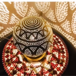 Round brass bedside lamp geometric light pattern detail