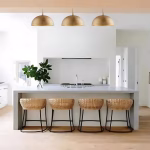 Three gold dome pendant lights illuminating kitchen island