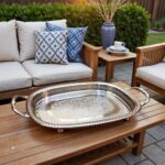 Moroccan silver-plated brass oval serving tray on an outdoor wooden patio table