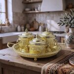 Three-vessel brass sugar bowl set on a textured wooden surface showcasing traditional Moroccan metalwork