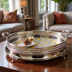 Elegant silver and gold big round tray serving coffee and desserts in upscale living room setting
