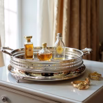 Luxury silver big round tray with gold accents holding perfume bottles on elegant white dresser