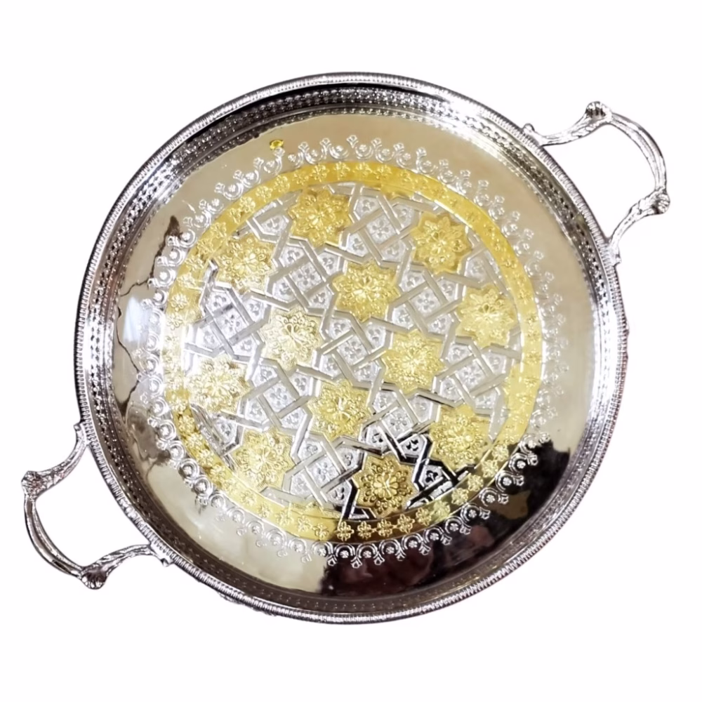 Overhead view of silver and gold big round tray showcasing intricate hand-engraved Moroccan geometric pattern