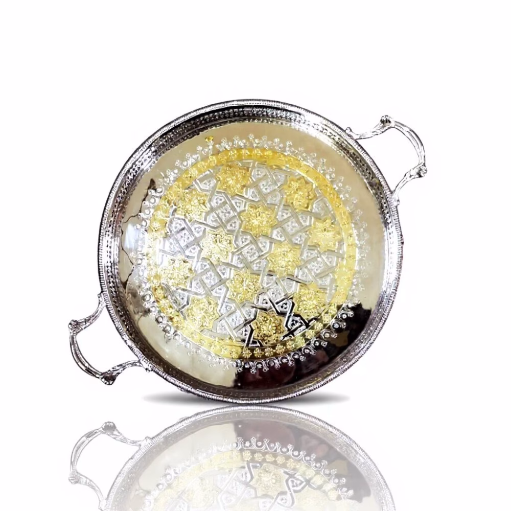 Overhead view of silver and gold big round tray showcasing intricate hand-engraved Moroccan geometric pattern