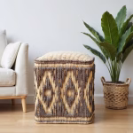 Scandinavian living room featuring artisan-made straw floor pouf with diamond motif