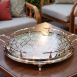 Silver large round tray with ornate gallery rail serving as stylish outdoor coffee table centerpiece