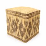 Isolated square straw floor pouf with a dark geometric diamond pattern on a clean white background.