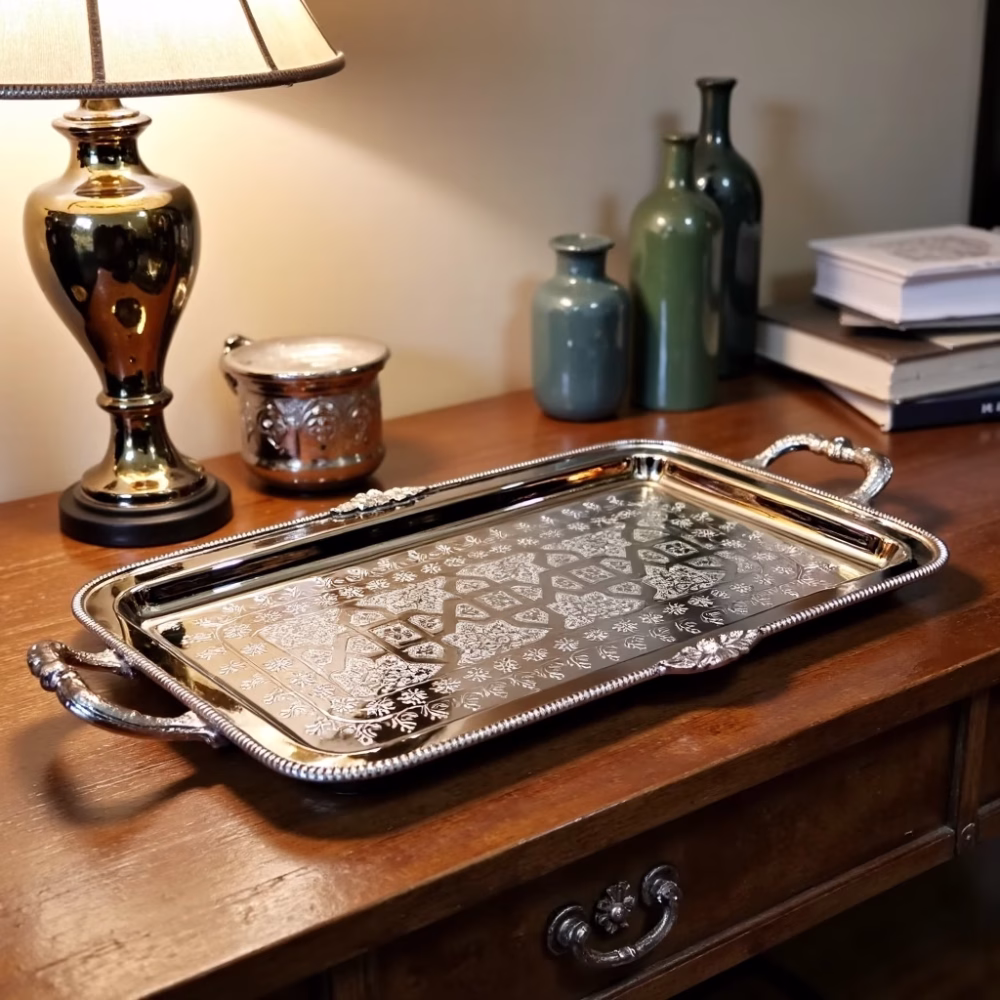 Decorative silver serving tray displayed on wooden console table with decorative accents