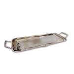 Hand-engraved silver serving tray with ornate handles shown from angle highlighting detailed craftsmanship